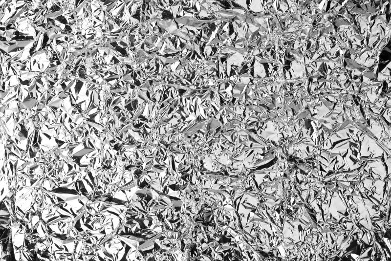 Skrynkligt försilvra skinande texturbakgrund för folie, den ljusa skinande festliga designen som är metallisk blänker den dekorat royaltyfri fotografi