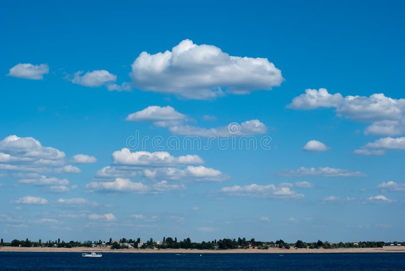 Sky with clouds ander the river, boat