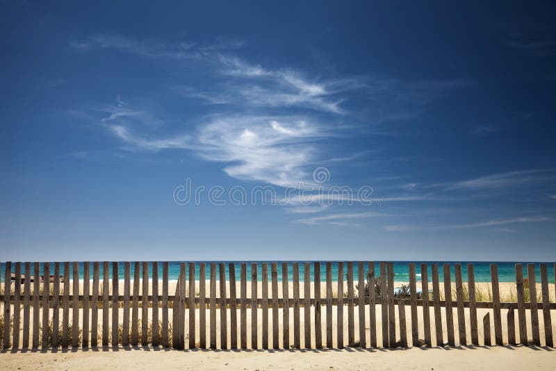 Sky with clouds on the beach with a wooden fence. Boardwalk rail stock images, royalty-free photos and pictures