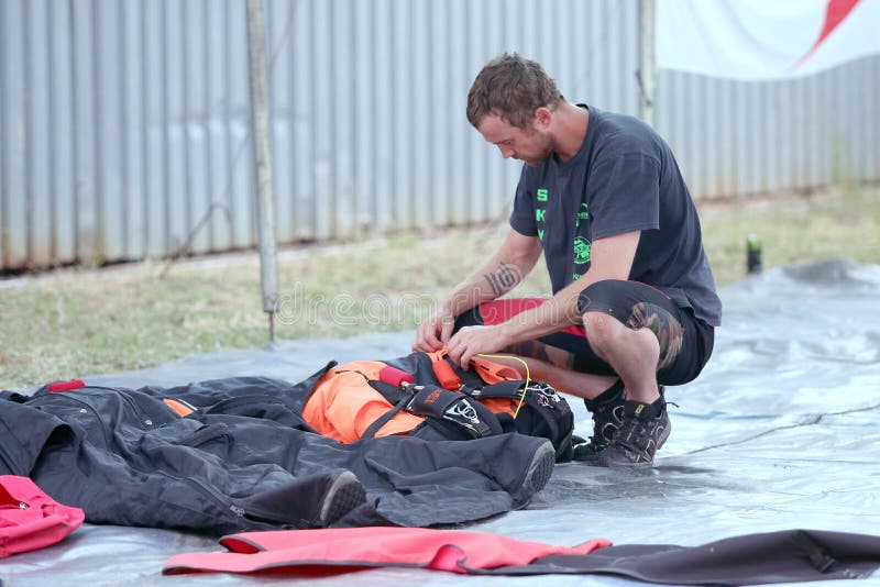 Sky diver packing and checking chute before next jump.