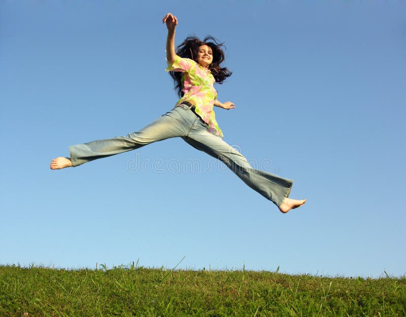 Jump girl with hair on blue sky green grass. Jump girl with hair on blue sky green grass