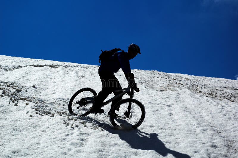 Sky, snow and mountain biker
