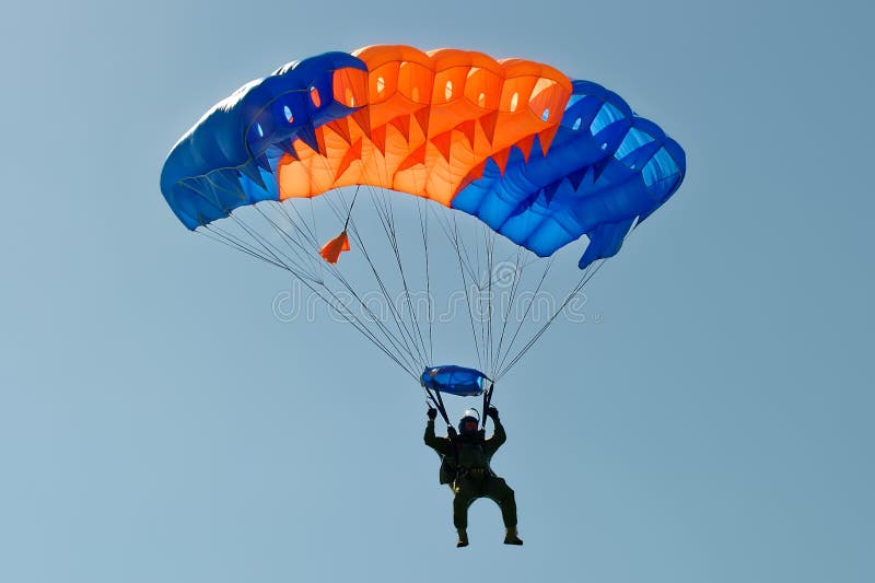 Kharkiv, Ukraine - August 20, 2016: Skydiver flying on colorful parachute at the airfield Korotych, Kharkov region, Ukraine on August 20, 2016. Kharkiv, Ukraine - August 20, 2016: Skydiver flying on colorful parachute at the airfield Korotych, Kharkov region, Ukraine on August 20, 2016