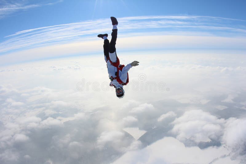 Skydiving. Skydiver is Falling Above Clouds. Stock Photo Image of