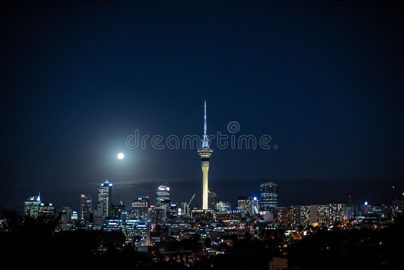 Skyline of Auckland with Illuminated Buildings and the Full Moon in the