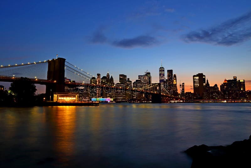 Skyline de New York City e ponte de Brooklyn do centro no por do sol fotografia de stock Skyline de New York City e ponte de Brooklyn do centro no por do sol fotografia de stock