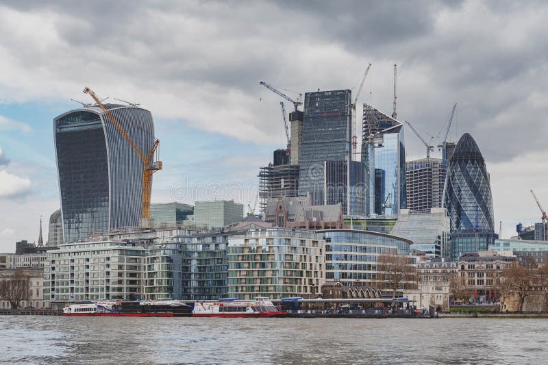 Skyline der Stadt von London durch die Themse mit den Wolkenkratzern und Gebäuden konstruiert im modernen Baustil lizenzfreies stockbild Skyline der Stadt von London durch die Themse mit den Wolkenkratzern und Gebäuden konstruiert im modernen Baustil lizenzfreies stockbild