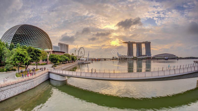 Skyline in Marina Bay with Esplanade Theaters on the Bay and Esplanade footbridge early morning timelapse in Singapore.