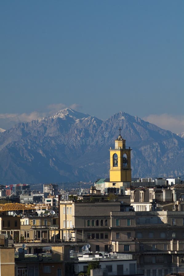 Skyline of Milan with Alps