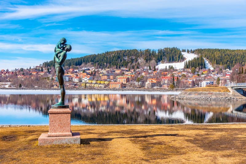 Skyline of Ostersund with a statue of father and a kid in Sweden