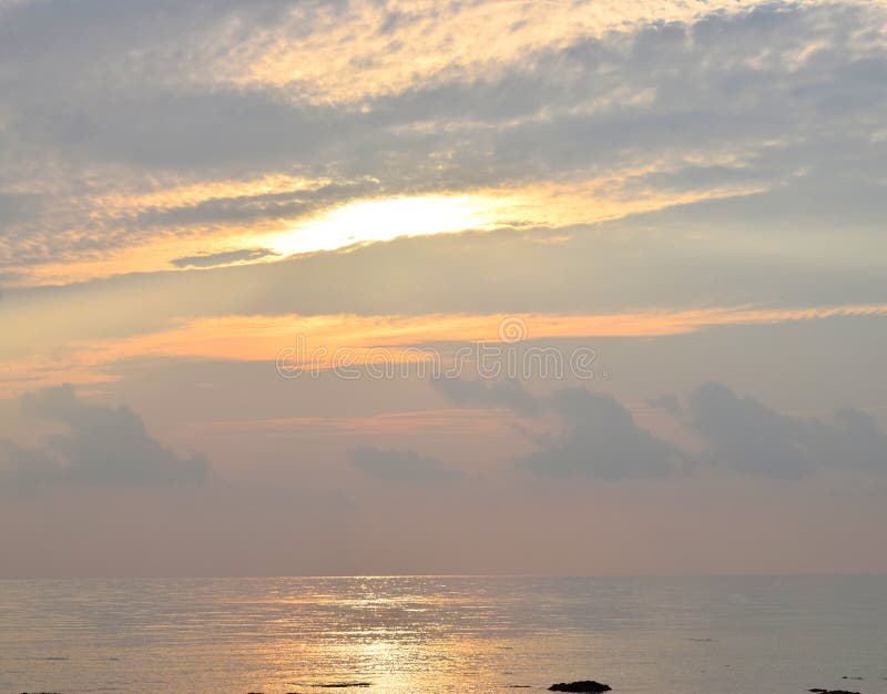 Sky With Sunbeams Radiating Out Under Colorful During A Sunset Stock