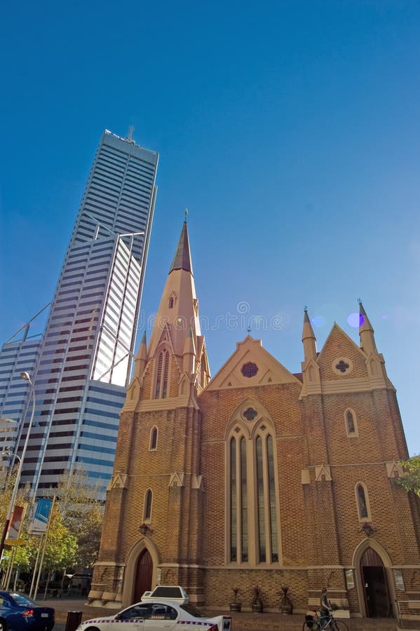 Skyscraper and church in city setting with traffic in Perth