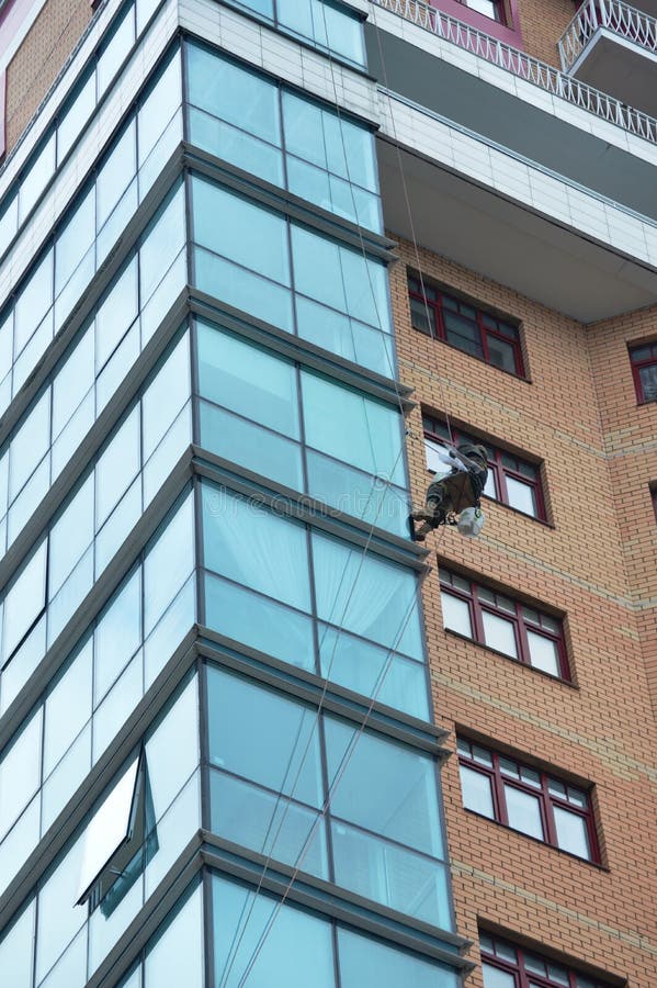 Skyscraper window cleaning stock image. Image of blue 254996355