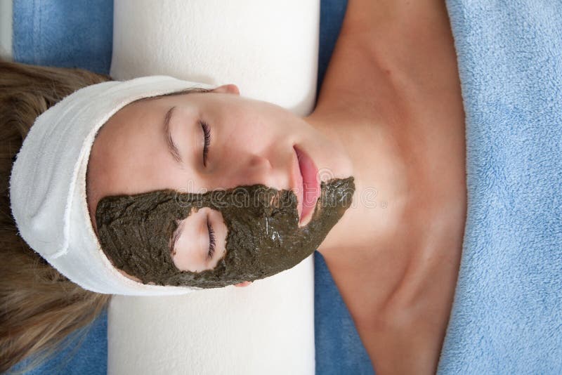 Attractive young woman geting seaweed beauty mask. Attractive young woman geting seaweed beauty mask