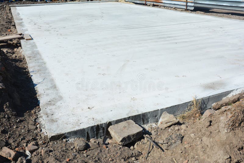 Slab-on-grade foundation on house construction site. Monolithic slabs are foundation systems constructed as one single concrete