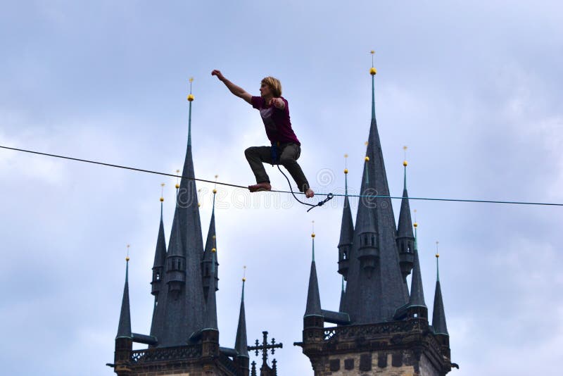 Slackline above Prague`s Old Town Square, between the Astronomical Clock and the opposite building