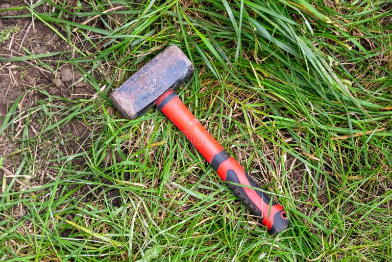 A Sledgehammer on the Green Grass. Stock Image Image of grunge