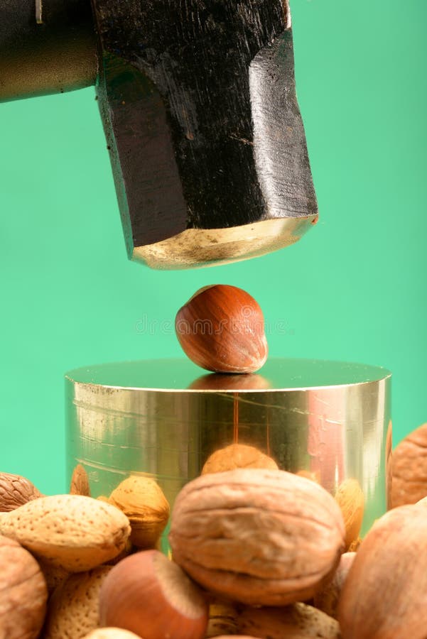 Sledgehammer to crack nuts stock photo. Image of crush 4977238