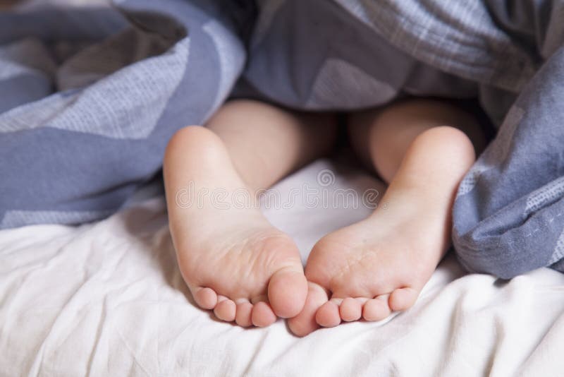 Sleep and relax concept. Beautiful groomed bare feet of cute little child girl. Sleep and rest concept.