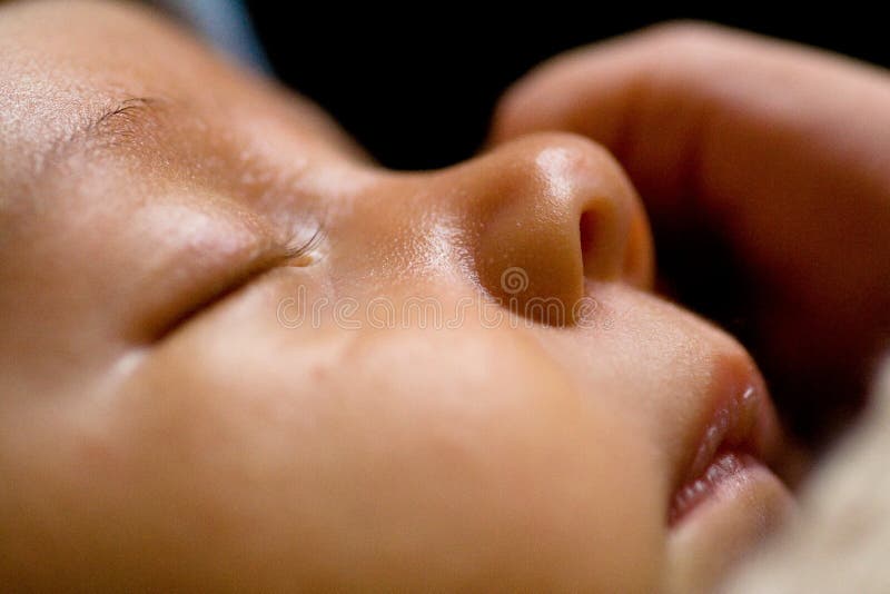 A close-up of a newborn baby sleeping peacefully. A close-up of a newborn baby sleeping peacefully