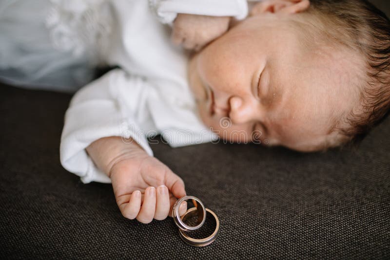Sleeping baby with wedding rings. Sleeping baby with wedding rings
