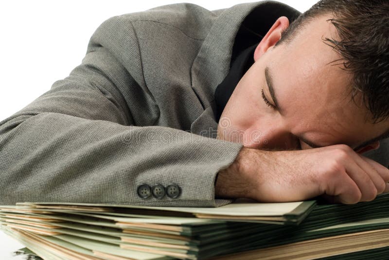 A young businessman who fell asleep on his paperwork. A young businessman who fell asleep on his paperwork