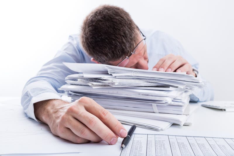 Tired businessman asleep at office desk full of papers. Shallow depth of field. Tired businessman asleep at office desk full of papers. Shallow depth of field.