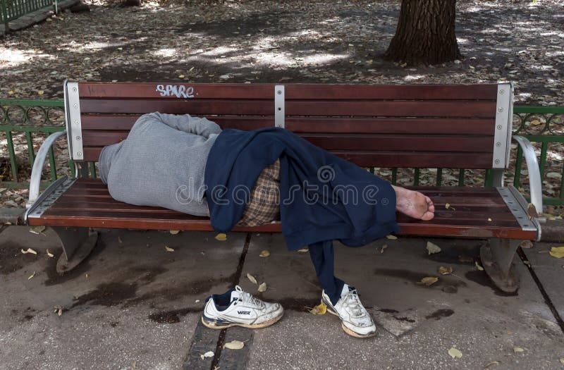 Sleeping homeless man on the bench