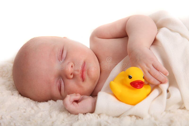 Sleeping Infant With a Rubber Duckie on White stock image Sleeping Infant With a Rubber Duckie on White stock image
