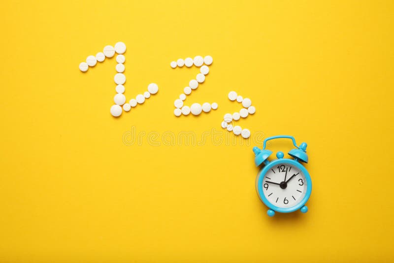 Sleeping Pills and an Alarm Clock, Insomnia Concept. Night Depression