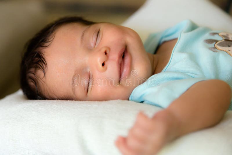 Sleeping smiling babyboy stock image. Image of hand, life 
