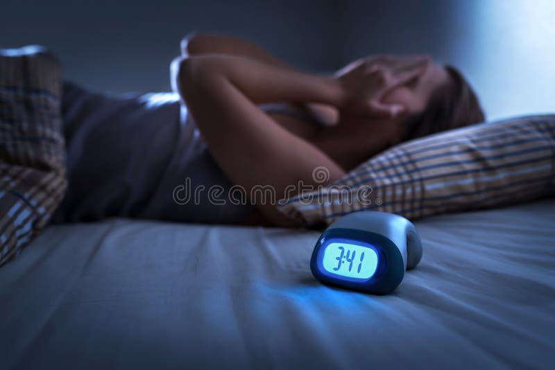 Sleepless woman suffering from insomnia, sleep apnea or stress. Tired and exhausted lady. Headache or migraine. Sleepless woman suffering from insomnia, sleep apnea or stress. Tired and exhausted lady. Headache or migraine.