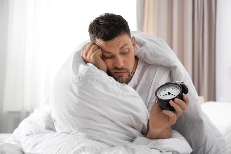 Sleepy Man With Alarm Clock At Home Stock Image Image Of Indoors