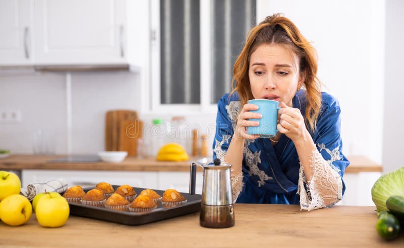 Sleepy Woman in Housecoat Drinking Morning Coffee in Kitchen Stock ...