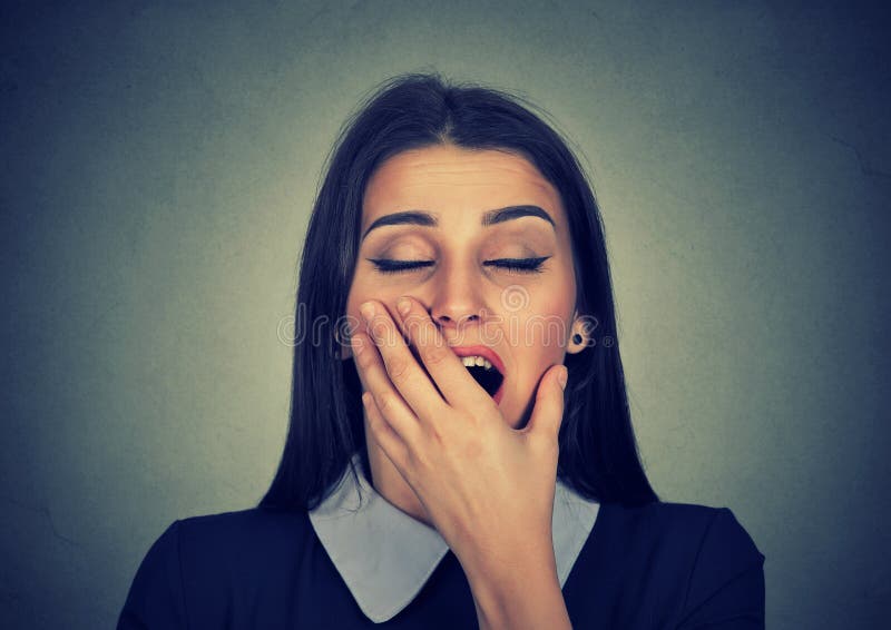 It is too early for meeting. Sleepy young woman with wide open mouth yawning eyes closed looking bored isolated on gray background. Face expression emotion body language. It is too early for meeting. Sleepy young woman with wide open mouth yawning eyes closed looking bored isolated on gray background. Face expression emotion body language