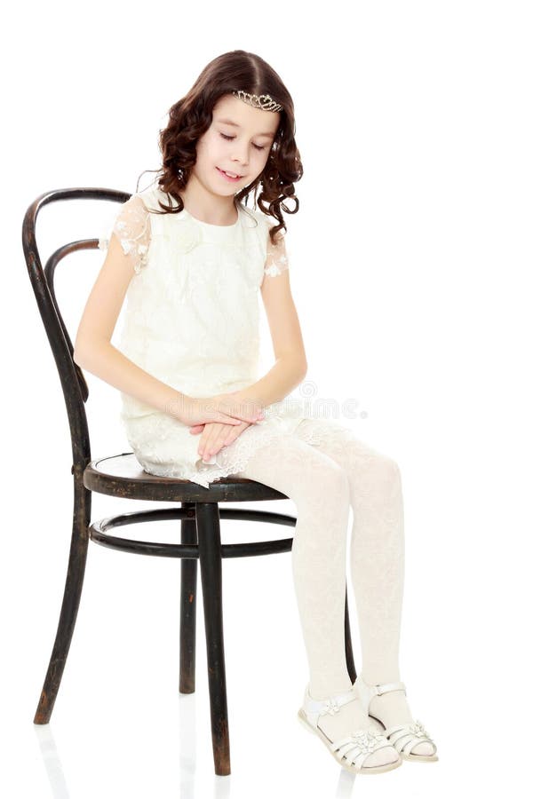 Slender little dancer posing near the old Vienna chair.