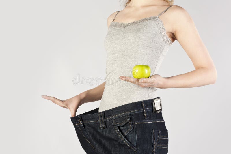 Slender young girl. Isolated over grey background.