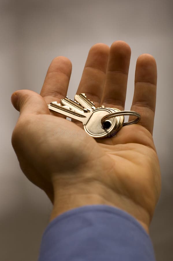 Business men hand holding keys close up. Business men hand holding keys close up