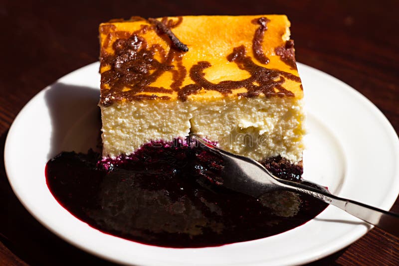 Slice Cheesecake with Blueberry Jam on Plate,brown Table,dessert Stock