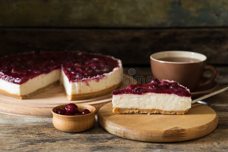 Slice of cheesecake with cup of tea on the table