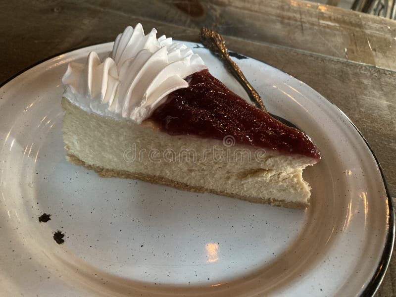 Slice Cheesecake with strawberry jelly, in a pewter plate ready for desser. Slice Cheesecake with strawberry jelly, in a pewter plate ready for desser