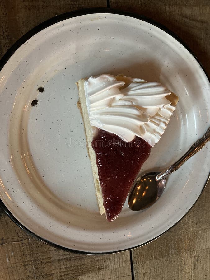 Slice Cheesecake with strawberry jelly, in a pewter plate ready for desser. Slice Cheesecake with strawberry jelly, in a pewter plate ready for desser