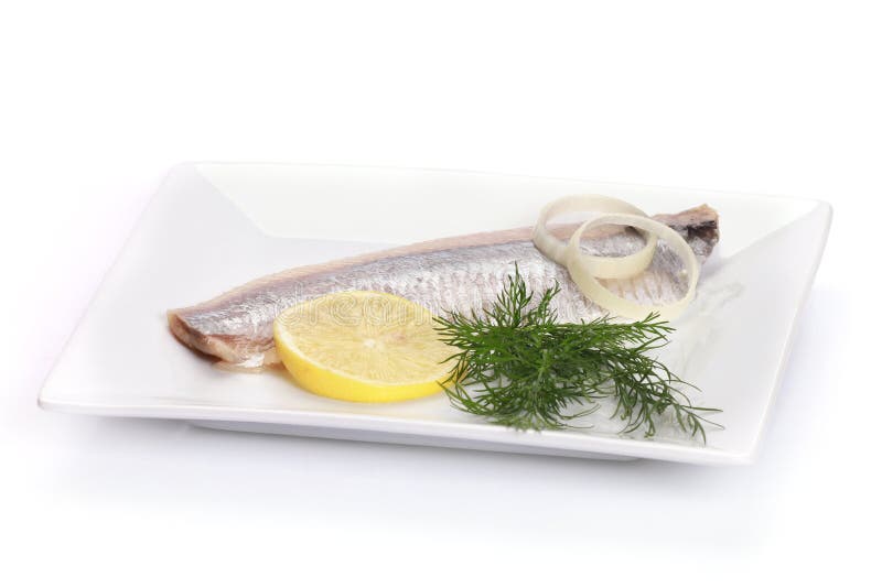 Slice of Marinated Fish with Lemon, Greens, and Onions on a Plate