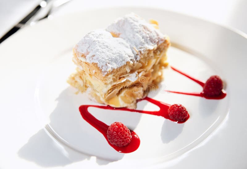 Slice of mille-feuille cake on porcelain plate