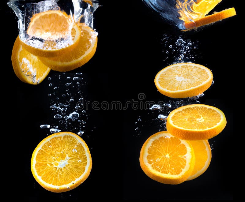 Sliced of Orange with Splashing Juice on White Background Stock Photo