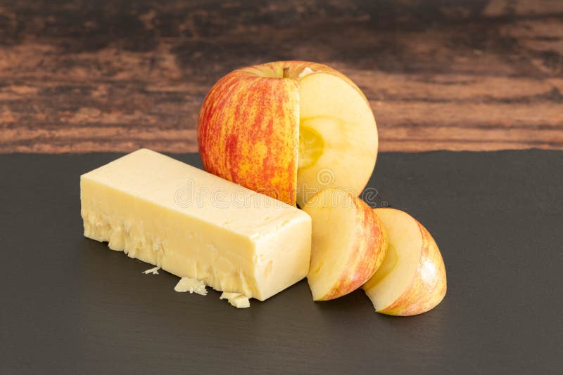 Sliced Apple and Cheddar Cheese on a Black Slate Board Stock Photo