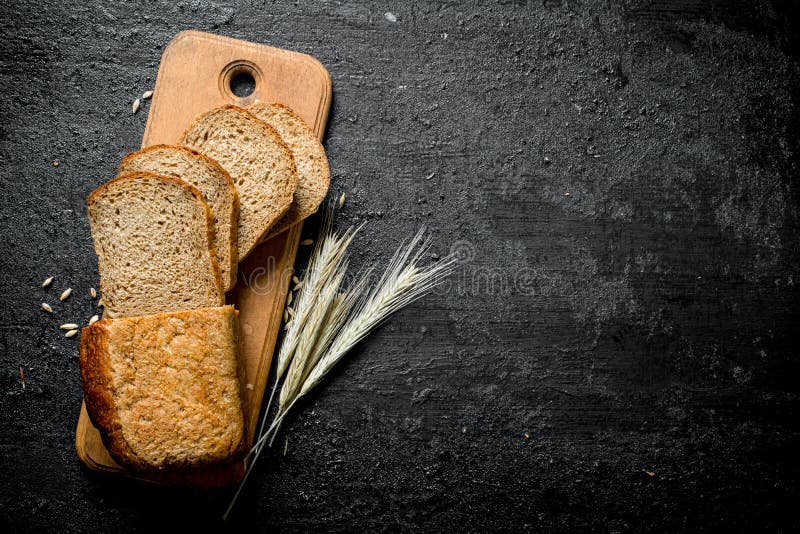 Sliced bread on a cutting Board with spikelets