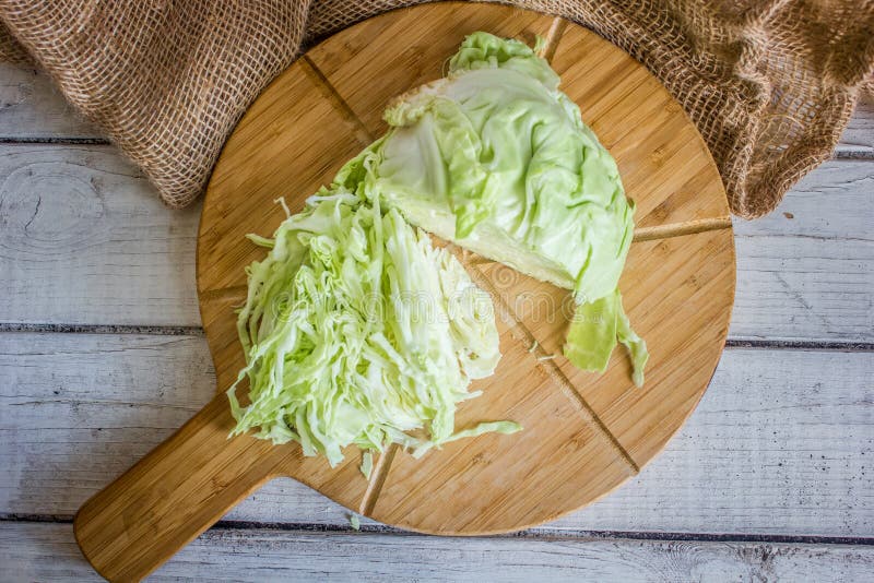 Sliced cabbage on a brown wood board stock photography