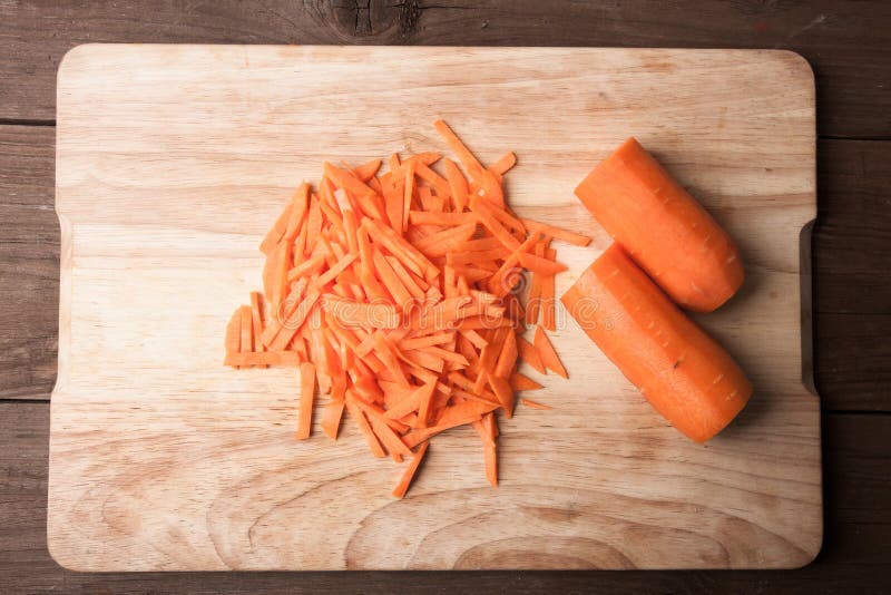 Sliced carrots on a wooden cutting board