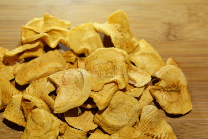 Sliced Dried Homemade Apple Chips on a Wooden Table Stock Photo Image